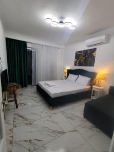 a bedroom with a large bed and a green curtain at Kariani Sea View Chic Apartment in Karianí +7 photos