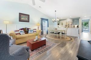 a living room with a couch and a table at 65D Isle Awhile condo in Pawleys Island +18 photos