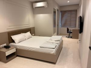 a bedroom with a bed and a television in it at Swarn Hotel in Kolkata