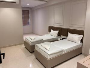 a room with two beds in a room at Swarn Hotel in Kolkata +75 photos