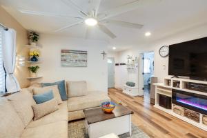 a living room with a couch and a flat screen tv at Half-Mi to Trails Pet-Friendly Home in Flagstaff! in Mountainaire