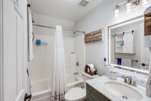a white bathroom with a sink and a toilet at Half-Mi to Trails Pet-Friendly Home in Flagstaff! in Mountainaire +18 photos