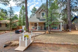 a house with a fence in front of a yard at Half-Mi to Trails Pet-Friendly Home in Flagstaff! in Mountainaire