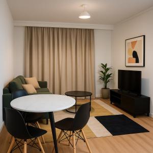 a living room with a couch and a table at Iris apartment in Perth