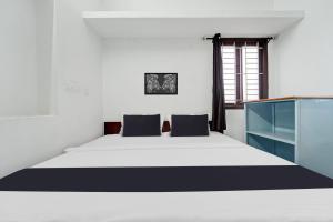 Ένα ή περισσότερα κρεβάτια σε δωμάτιο στο Hotel O Kayilai Homestays