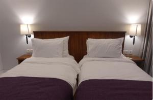 two beds sitting next to each other in a bedroom at Near to The Beach Ayunjani Villa, Bali in Ketewel +5 photos