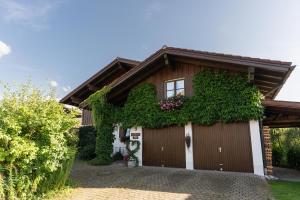 ein Haus mit einer efeubewachsenen Garage in der Unterkunft Ferienwohnung Martin OA in Sonthofen
