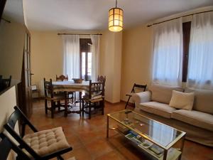 a living room with a couch and a table at Encanto del Gregorio in Huerta del Marquesado