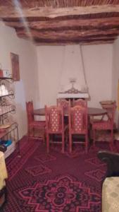 a dining room with a table and chairs in a room at Riad louban in Essaouira