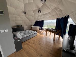 a room with a bed and a table in a tent at Glamp Ojcowska in Jerzmanowice