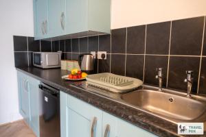 a kitchen counter with a sink and a microwave at The Bird's Nest - Free Parking! in Boscastle +57 photos