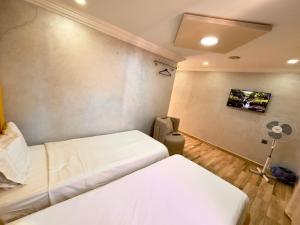 a room with two beds and a tv on the wall at villa Duplex in Sale +4 photos