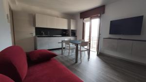 a living room with a red couch and a table at The View 2 in Teglio