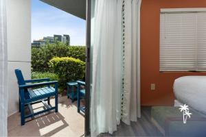 a bedroom with a balcony with a bed and a window at Boho Chic Garden Condo 7 Min to Universal Parks in Orlando