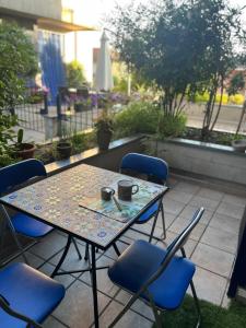 a table and chairs with two cups on a patio at Tomati's House in Alba