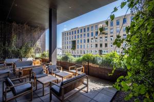 a balcony with tables and chairs and a building at Comwell Copenhagen Portside Dolce by Wyndham in Copenhagen