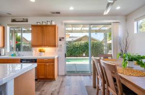 a kitchen with a table and a dining room at Oasis in Indio, La Quinta with Private Pool & Spa in Indio