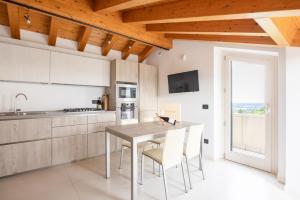 a kitchen with a table and chairs and a window at Zardo Winery in San Pietro in Cariano