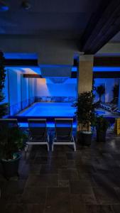 a swimming pool at night with blue lights at Pensiunea Senin in Sovata