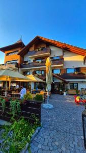 a building with an umbrella in front of it at Pensiunea Senin in Sovata