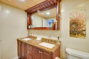 a bathroom with a sink and a mirror at Adirondacks Cabin Fish, Hunt and Hike! in Glenfield +30 photos