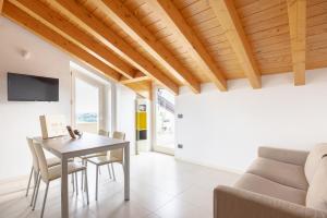 a dining room with a table and a couch at Zardo Winery in San Pietro in Cariano