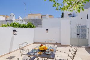 a table and chairs with a bowl of fruit on it at Ikia Damianou Traditional House in Archangelos