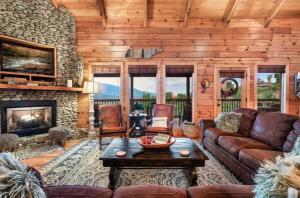 a living room with a couch and a fireplace at Two Mountain Cabins with Views & Hot Tub Fun in Gatlinburg +90 photos