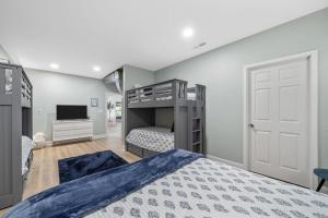 a bedroom with a bunk bed and a tv at Bluebird Sanctuary w Stunning Sunset Views Sleeps 28 in Big Sandy