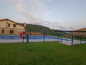 a tennis court with a volley ball hoop at Encanto del Gregorio in Huerta del Marquesado