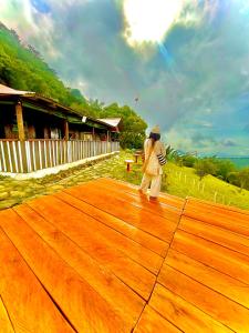 a man is flying a kite on a wooden floor at Ecolodge Maruamake in Santa Marta