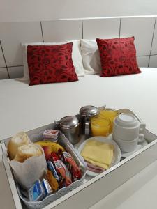 a drawer filled with food on a bed at Hotel Kingite in Sao Paulo