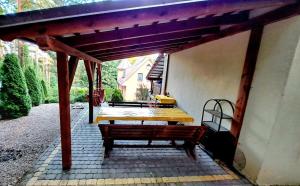 a pavilion with a wooden bench on a patio at Zofia in Struga