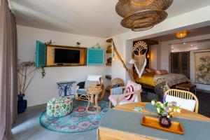 a living room with a bed and a room with a table at Mijn-Habitat in Valkenburg