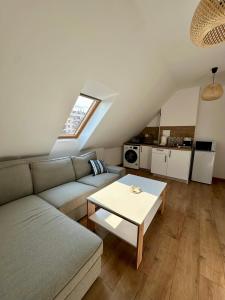a living room with a couch and a table at Гнездото l The Nest in Burgas City