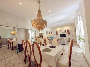 a dining room and living room with a table and chairs at Portrait Boutique Villa in Valencia