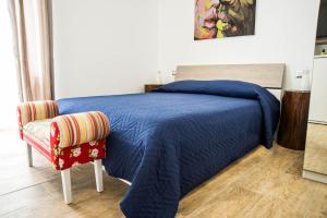 a bedroom with a blue bed and a chair at Brezza Marina by Paolo in Barletta
