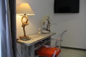 a room with a table with a lamp and a chair at Brezza Marina by Paolo in Barletta +28 photos