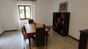 a dining room with a table and chairs and a cabinet at The Heritage Home in Novate Mezzola +10 photos