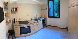 a kitchen with a sink and a counter top at The Heritage Home in Novate Mezzola