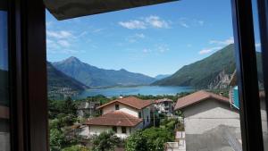 a view of a lake and mountains from a window at The Heritage Home in Novate Mezzola