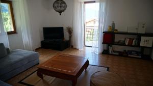 a living room with a couch and a coffee table at The Heritage Home in Novate Mezzola