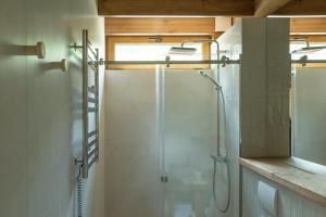 a bathroom with a shower with a glass door at Zarichka in Zachepilovka