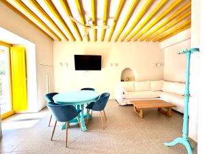 a living room with a table and a couch at Callisso Mykonos in Mikonos