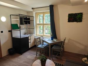 a kitchen and dining room with a table and a dining room at Vila Mezi Časy in Trutnov