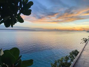 a view of the ocean at sunset at Bara Village Guest House Bira in Bira