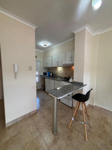 a kitchen with a table and a chair in a room at Departamento centrico Avenida Cordoba Edificio Campanarios XIX in Esperanza