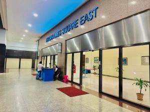 two people standing in the lobby of a building at Luxy Service Apartment at Times Square KL in Kuala Lumpur +67 photos