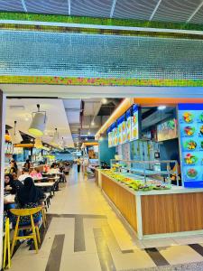 a fast food restaurant with people sitting at tables at Luxy Service Apartment at Times Square KL in Kuala Lumpur