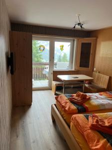 a room with two beds and a table in it at Goliath 44 & 45 in Leukerbad